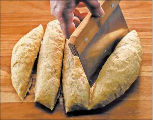  ?? ZBIGNIEW BZDAK/CHICAGO TRIBUNE PHOTOS; SHANNON KINSELLA/FOOD STYLING ?? Cut the taralli dough into long sections, then cut those into pieces the size of a whole walnut. Roll each into a log.