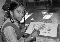 ?? SANJEEV KUMAR/HT ?? Rekha Devi of Government Primary School, Rampura Phul, showing a sample of her calligraph­y.