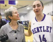  ?? Ted Fitzgerald / Associated Press ?? Bentley coach Barbara Stevens celebrates her 900th win with senior forward Lauren Battista after a Jan. 25, 2014, game in Waltham, Mass. Stevens could join the 1,000-victory club on Wednesday.