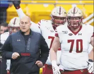  ?? Keith Srakocic / Associated Press ?? Boston College coach Steve Addazio leads his team onto the field against Pittsburgh on Saturday in Pittsburgh. Addazio was fired on Sunday.