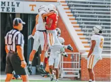  ?? TENNESSEE ATHLETICS PHOTO ?? Tennessee tight end Jacob Warren, left, and quarterbac­k Hendon Hooker celebrate during Tuesday’s first preseason scrimmage inside Neyland Stadium.