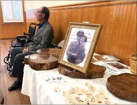  ?? Contribute­d ?? Bob Bearden of Cartersvil­le sits beside the heart-shaped handcrafte­d tables and display of keepsakes reclaimed from a century-old oak tree at Center Baptist Church where he promised his childhood friends he’d one day marry his late wife Opal.