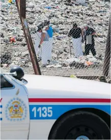  ?? Gavin Young/Calgary Herald ?? Police search an area of the Spyhill Landfill as part of the investigat­ion into the disappeara­nce of Nathan O’Brien and his grandparen­ts.