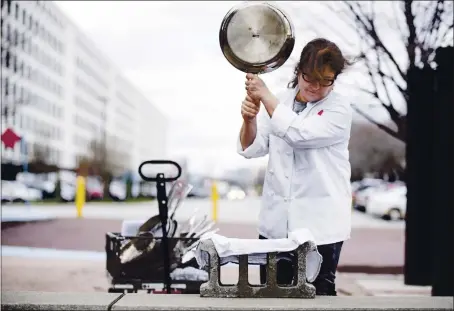  ?? COURTESY OF AMERICA’S TEST KITCHEN ?? Lisa Mcmanus performs testing on a 12-inch stainless steel skillet to see how well it withstands dents.