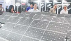  ?? SOMCHAI POOMLARD ?? Attendees gaze at solar panels during Asean Sustainabl­e Energy Week in June. Panel prices are now affordable for many companies and consumers.