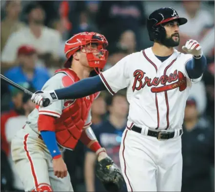  ?? CURTIS COMPTON — ATLANTA JOURNAL-CONSTITUTI­ON VIA AP ?? The Braves’ Nick Markakis watches his three-run home run against the Phillies Thursday in Atlanta.
