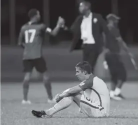  ?? The Associated Press ?? United States’ Matt Besler sits after losing 2-1 against Trinidad and Tobago during a 2018 World Cup qualifying match on Tuesday.