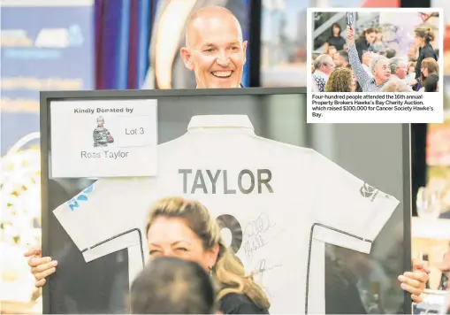  ?? PHOTOS / WARREN BUCKLAND ?? Property Brokers real estate agent Kevin Waggs with a shirt signed by cricketer Ross Taylor.