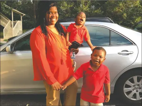  ?? (Courtesy Photos) ?? Saferia Johnson of Thomasvill­e, Ga., holds sons Kyrei (center) and Josiah. In August, Johnson died at age 36 from covid-19.