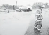  ??  ?? Wellesley Fire’s Rich Hurren keeps traffic off the road.