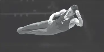  ?? BEN STANSALL/GETTY IMAGES ?? U.S. gymnast and 2016 Olympian Chris Brooks performs at the 2015 World Championsh­ips in Glasgow, Scotland.