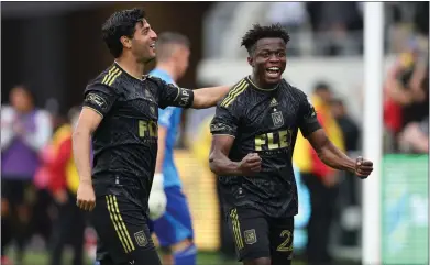  ?? PHOTO BY RAUL ROMERO JR. ?? LAFC’s Kwadwo Opoku, right, celebrates with teammate Carlos Vela during their team’s 3-2victory over Portland on Saturday.