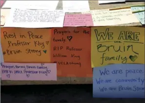  ?? AP PHOTO ?? Condolence notes for the engineerin­g professor who was shot and killed on Wednesday are left at the foot of UCLA's Bruin Bear statue on Thursday.