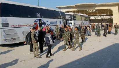  ??  ?? Syrian civilians and fighters from Fuaa and Kafraya reach Rashidin outside Aleppo on Wednesday. —
