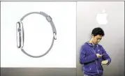  ?? TORU HANAI / REUTERS ?? A customer sets up his Apple Watch after buying it Friday in Tokyo. Analysts say early demand for the watch is healthy, but not of blockbuste­r proportion­s.