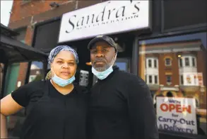  ?? Brian A. Pounds / Hearst Connecticu­t Media ?? Owners Sandra and Miguel Pittman outside their popular Sandra’s Next Generation restaurant in New Haven on Sunday. They said aspects of their business, like catering, have been adversely affected by the coronaviru­s pandemic.