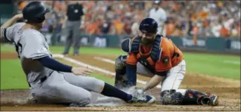  ?? TONY GUTIERREZ — THE ASSOCIATED PRESS ?? Houston catcher Brian McCann tags out the Yankees’ Greg Bird at home during the fifth inning Friday in Houston.