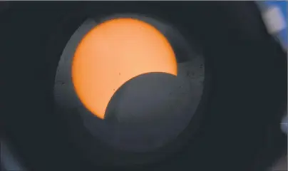  ?? STAN WILLIAMS PHOTO ?? This picture of the solar eclipse was taken with a Nikon camera through the specially filtered lens of a Meade LX200 EMC telescope. The telescope lens was covered by a film of Mylar, a synthetic material that makes it possible to look at the sun...