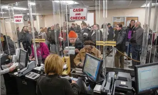  ?? HOWARD SCHNAPP / ASSOCIATED PRESS ?? Hempstead, N.Y.: People line up Tuesday at the Hempstead tax receiver’s office to pay their real estate taxes before the end of the year. Similar efforts in Georgia are being rejected by county tax officials who say 2018 taxes can’t be collected until...