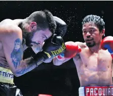  ?? YAM G-JUN/ASSOCIATED PRESS ?? Lucas Matthysse of Argentina, left, takes a hard shot from Manny Pacquiao of the Philippine­s during their WBA World welterweig­ht title bout in Kuala Lumpur, Malaysia on Sunday.