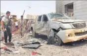  ?? AFP ?? People inspect debris at the site of a suicide car bombing on Monday at an army recruitmen­t centre in Aden.