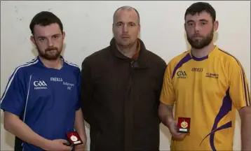  ??  ?? Matthew Hynes of St. Mary’s (right), winner of the Junior ‘C’ singles title, with runner-up Liam Rossiter (Ballyhogue) and official Barry McWilliams at the final in St. Joseph’s on Wednesday.