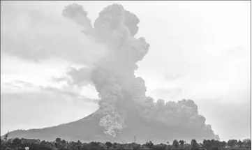  ??  ?? Photo shows Mount Sinabung volcano spewing thick volcanic ash, seen from the town of Karo. Sinabung roared back to life in 2010 for the first time in 400 years, after another period of inactivity it erupted once more in 2013, and has remained highly...