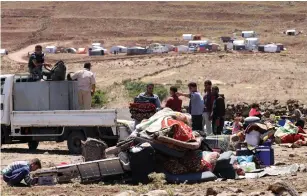  ?? (Alaa al-Faqir/Reuters) ?? PEOPLE DISPLACED from Daraa province move their belongings near the Golan Heights last week in Quneitra, Syria.