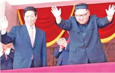  ??  ?? Kim (right) and Li wave while attending a military parade marking the 70th anniversar­y of North Korea’s foundation in Pyongyang, North Korea. — Reuters photo