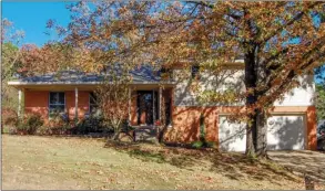  ?? PHOTOS BY LINDA GARNER-BUNCH/Arkansas Democrat-Gazette ?? Mature trees shade this tri-level home, which has three bedrooms, two-and-a-half baths, two living areas and a fully fenced backyard. The home rests on a quiet street in west Little Rock.