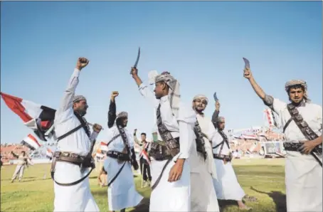  ?? HANI MOHAMMED — THE ASSOCIATED PRESS ?? Supporters of Houthi Shiites, who took over the government of Yemen and installed a new committee to govern, wave traditiona­l daggers and chant slogans at a rally in support of the Houthis at a sports stadium in Sanaa, Yemen, on Saturday.