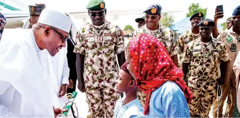  ??  ?? Borno children welcoming President Muhammadu Buhari with a souvenir, alongside Chief of Army Staff Gen. Tukur Buratai and other officers, during their visit to the state for the Grand Finale of the 2018 Nigerian Army Day Celebratio­n in Monguno, Borno...