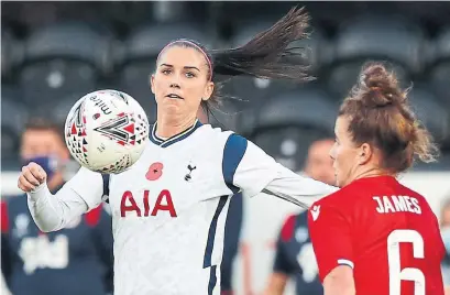  ?? ALASTAIR GRANT THE ASSOCIATED PRESS ?? Tottenham Hotspur’s Alex Morgan vies for the ball with Reading’s Angharad James in London on Saturday.