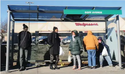  ?? Photo by Ernest A. Brown ?? RIPTA riders wait for the next bus on a frigid morning at Goff Avenue in Pawtucket last week.