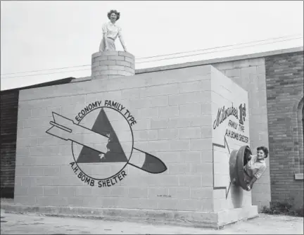  ?? ASSOCIATED PRESS FILE PHOTO ?? In this Sept. 12, 1958 file photo, Beverly Wysocki, top, and Marie Graskamp, right, emerge from a new family-type bomb shelter on display in Milwaukee, Wis. For some baby boomers, North Korea’s nuclear advances and the Trump administra­tion’s bellicose response have prompted flashbacks to a time when they were young, and when they prayed each night that they might awaken the next morning. For their children, the North Korean crisis was a taste of what the Cold War was like.