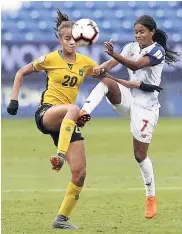  ??  ?? Jamaica midfielder Giselle Washington (left) and Panama midfielder Kenia Rangel battle for the ball during the first half of the third-place match of the Concacaf women’s World Cup qualifying tournament, yesterday.