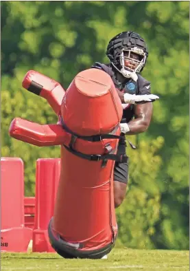  ?? ?? Above left: Atlanta Falcons defensive tackle Grady Jarrett (97) does a drill during training camp at IBM Performanc­e Field. makes a catch in a drill.