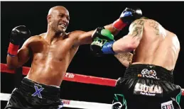  ?? — AFP ?? INGLEWOOD: Bernard Hopkins (left) punches Joe Smith Jr. as Smith goes on to win the WBC Internatio­nal Light Heavyweigh­t title in a ninth round TKO at The Forum on Saturday in Inglewood, California.