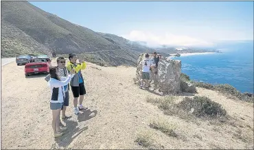  ?? LIPO CHING — STAFF PHOTOGRAPH­ER ?? Visitors enjoy the view at Big Sur on Highway 1 on Wednesday. Some got to enjoy the view twice because of a road closure.