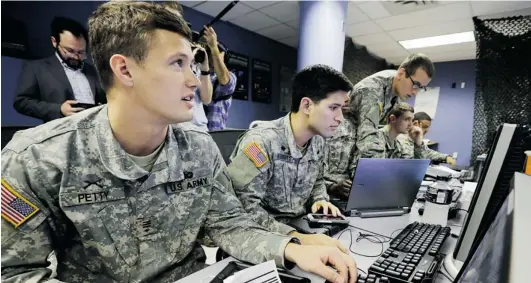  ?? MEL EVANS/ THE ASSOCIATED PRESS ?? Cadets at West Point study their screens as they fend off cyber attacks this week during exercises that pit the fi ve U. S. military academies against each other.