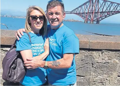  ??  ?? Katie Swales with proud father Vince, where her charity abseil raised £3,000 for Parkinson’s UK.