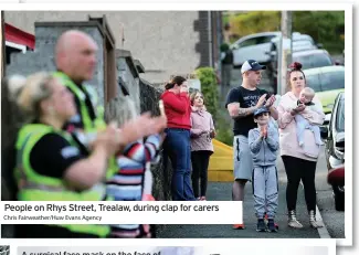  ?? Chris Fairweathe­r/Huw Evans Agency ?? People on Rhys Street, Trealaw, during clap for carers