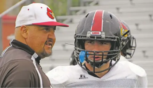  ?? PHOTOS BY WILL WEBBER/THE NEW MEXICAN ?? Robertson head coach Leroy Gonzalez, left, has made junior Santiago Gonzales his starting running back. The Cardinals return six starters on offense. One of the most dominant teams the past three years in Class 4A, the team would to return to the title...