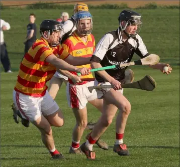  ??  ?? Jimmy Sutton of Fethard under pressure from Pádraig Flynn and Mick Sweeney (Monageer-Boolavogue).