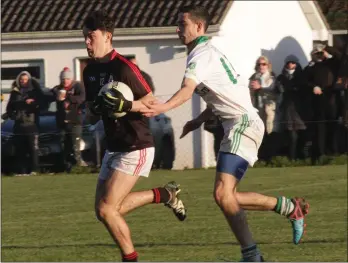  ??  ?? Quinn Saunders of Forth and Bargy Gaels tries to evade the challenge of Glen Murphy.