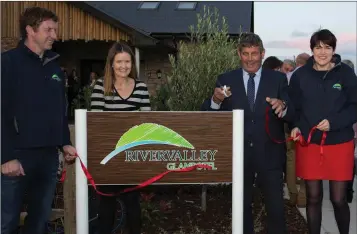  ??  ?? Minister of State Andrew Doyle cuts the ribbon at the official opening of River Valley Glampotel in Redcross alongside Ashley and Leah Williams and Lorna Williams.