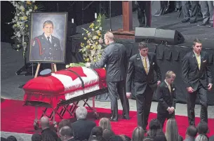  ?? DARREN CALABRESE PHOTOS/THE CANADIAN PRESS ?? Steven Burns lays a flower on the casket of his wife, Const. Sara Burns.