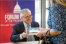  ?? ALLEN EYESTONE / THE PALM BEACH POST ?? Jon Meacham greets a visitor as he signs books Tuesday. In his speech, the author said that Americans should not “shout at each other because that’s not going to be true to that promise of the American Revolution.”