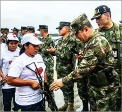  ?? ARMY OF COLOMBIA/AFP ?? Members of ELN, which demobilise­d on October 17, hand their weapons to Colombian Armed Forces troops in Buenaventu­ra on October 18, just days before peace talks are set to open.