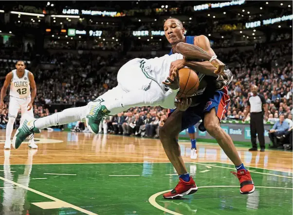  ??  ?? Barging through: Detroit Pistons’ Avery Bradley (right) grabbing Boston Celtics’ Kyrie Irving in the NBA game on Monday. — Reuters